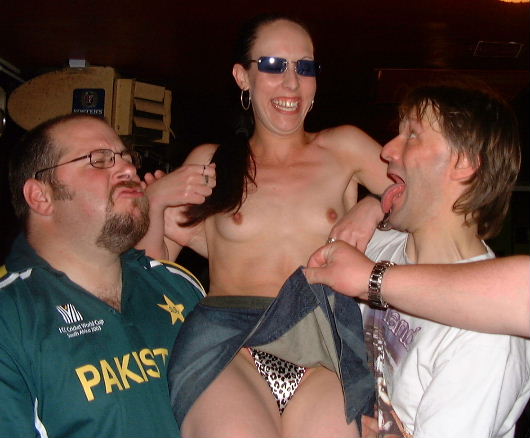 Pav and Jesus pull faces with the topless barmaid at the Variety club Radford.